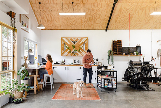 Doug and Danika in their D&D Letterpress Studio with Huxley the dog keeping watch